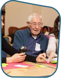 Aging and young adults playing cards