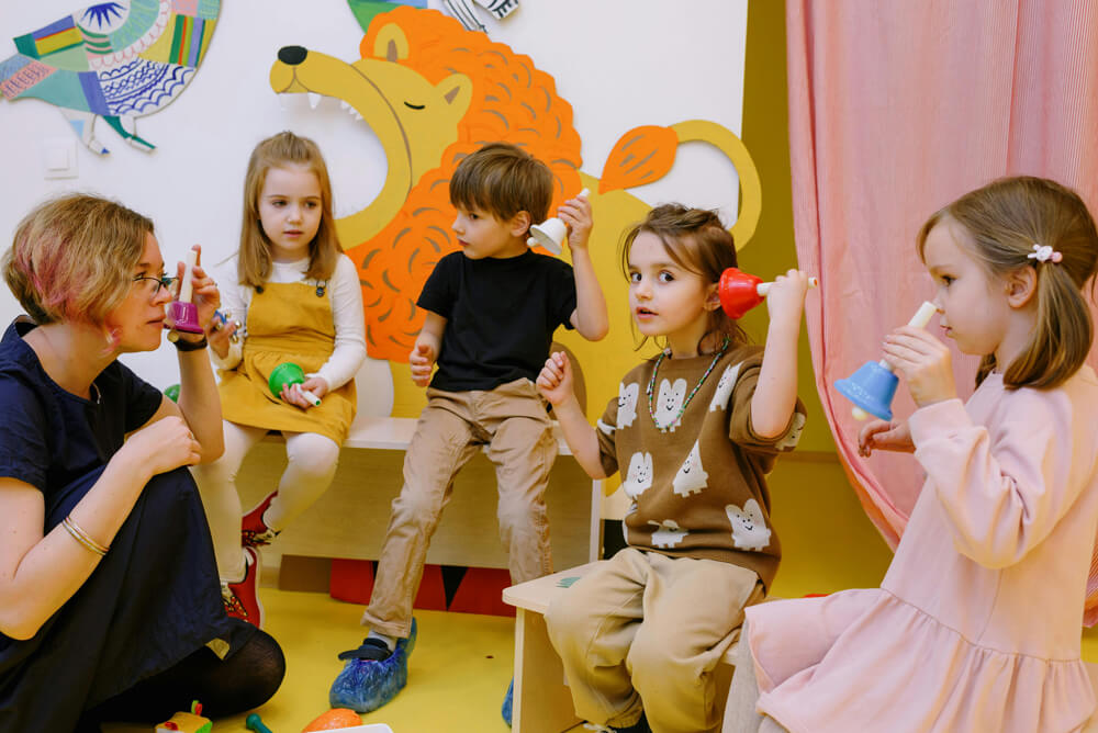 image of Young children playing with handheld bells as part of a kids music class
